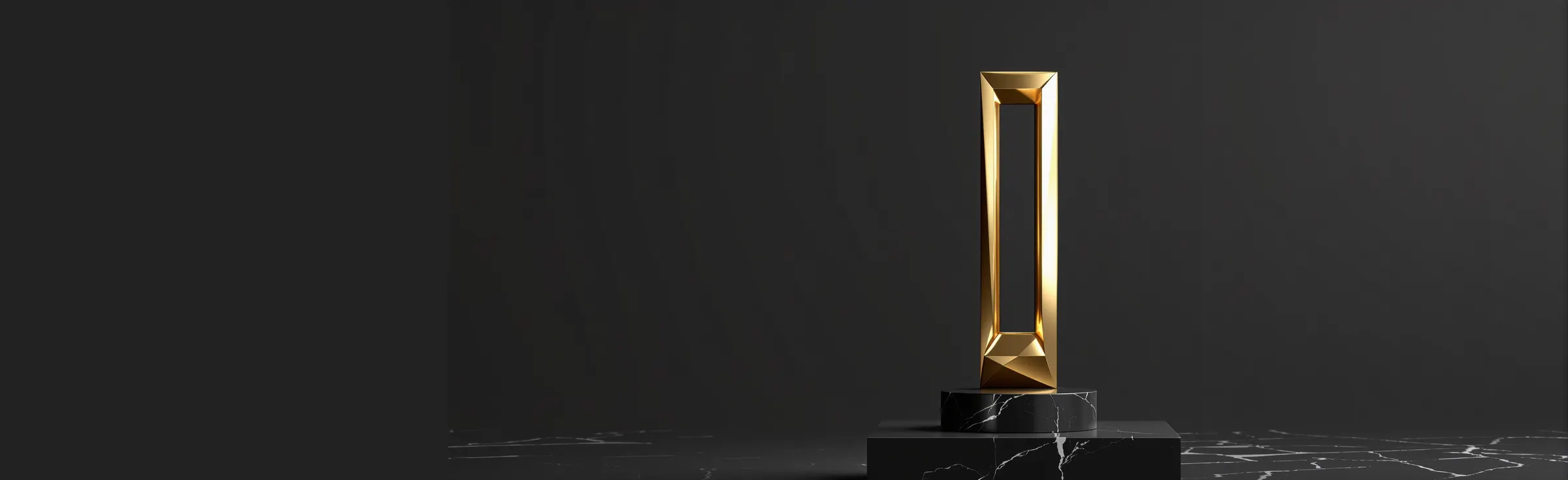 The websbz award, a gold frame sculpture on a black stone plinth